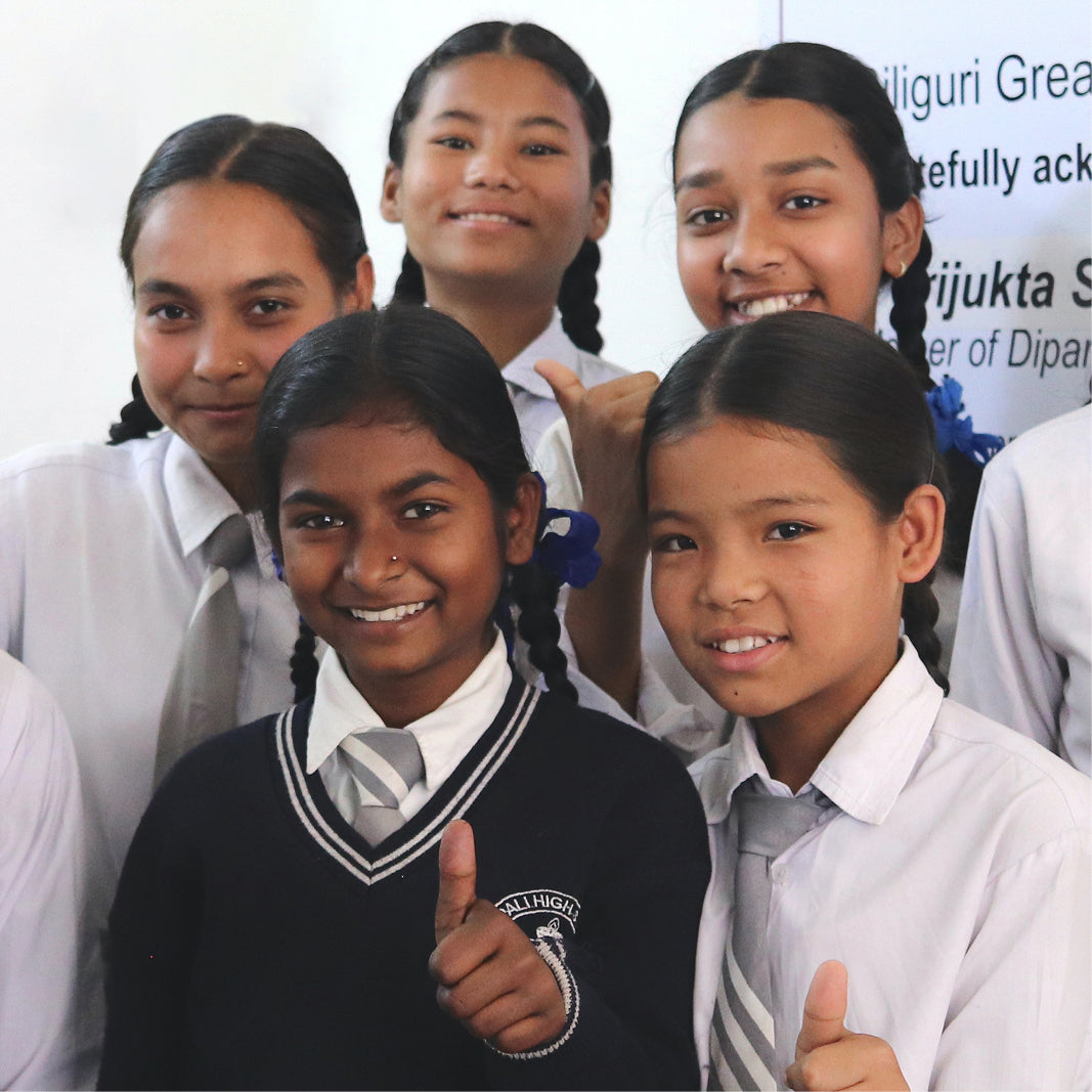 Group of children representing the impact of the ‘Buy a Frame, Help a Child See’ program by MODO Eyewear.