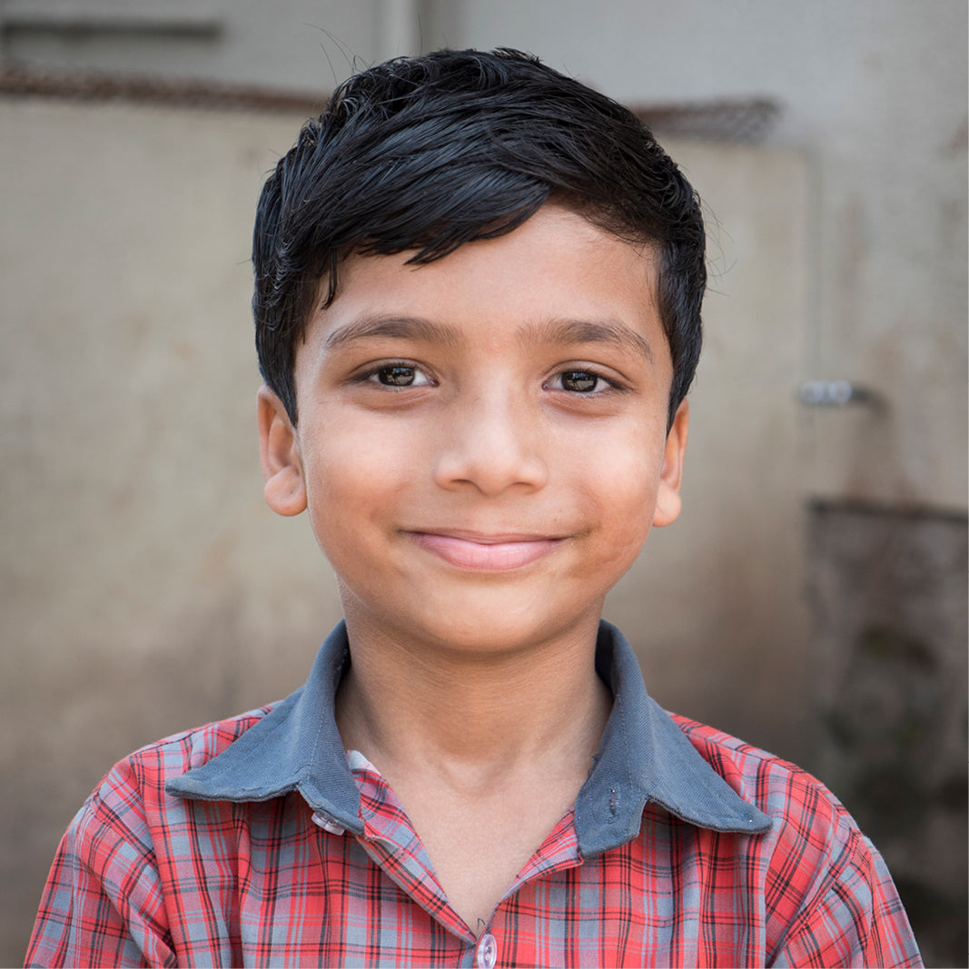Close-up of a child representing the impact of the ‘Buy a Frame, Help a Child See’ program by MODO Eyewear.